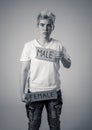 Transgender teenager breaking the word FEMALE into MALE. Gender identity and human rights concept