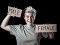 Transgender teenager breaking the word FEMALE into MALE. Gender identity and human rights concept