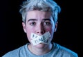 Conceptual image of censorship and gender identity. Transgender teenager with mouth sealed