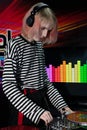 Transgender tunes DJ equipment touches the red record with one hand, turns the controller with the other