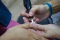 Transgender woman in the beauty salon and she is getting a manicure by the professional nail stylist. Beauty and health center.