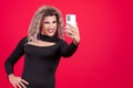 Transgender woman with make up taking a selfie with mobile