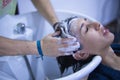 Transgender woman shampooing her hair for a keratin treatment at a hair salon. Transgender concept, hairdresser, beauty