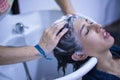 Transgender woman shampooing her hair for a keratin treatment at a hair salon. Transgender concept, hairdresser, beauty