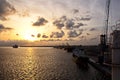 Transhipment terminal for discharging cement cargo by shore cranes. A view of berths with cargo ships and the water area of the po