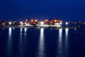 Transhipment terminal for discharging cement cargo by shore cranes. A view of berths with cargo ships and the water area of the po