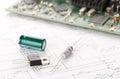 Transistor, resistor and capacitor electronic parts or components in front of pcb board with pcb wiring diagram - electronic Royalty Free Stock Photo