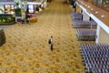 Transit hall shopping area in Changi Airport Terminal 1; empty. Rows of parked luggage trolleys; no people Royalty Free Stock Photo