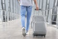 Transit Passenger Concept. Unrecognizable Man Walking With Suitcase In Airport Terminal Royalty Free Stock Photo