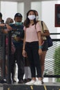 Transjakarta passengers at busway stops who are required to wear nose masks