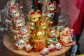 Multiple traditional Japanese maneki neko beckoning cat moving paw figurines on a store display, group of objects Royalty Free Stock Photo