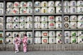 Translation: girls in kimono in front of drums or barrels of sake (Japanese alcoholic drinks) at Tsurugaoka shrine