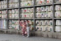 Translation: girls in kimono in front of drums or barrels of sake (Japanese alcoholic drinks) at Tsurugaoka shrine