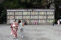 Translation: girls in kimono in front of drums or barrels of sake (Japanese alcoholic drinks) at Tsurugaoka shrine