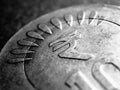 Translation of the inscription: rupee. Fragment of Indian 10 rupee coin with the sign of national currency close up. Dramatic dark