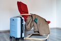 Translation: military id. Travel bag stands near red armchair with coat.