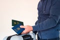 Translation: military id, Ukraine passport. Civil man in blue sweatshirt holding travel bag, passport