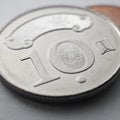 Translation: 10 New Taiwan dollars. Taiwanese coins lie on light surface. Square illustration on theme of economics or banking.