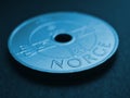 Translation: Norway. 1 Norwegian krone coin close-up. National currency of Norway. Blue tinted money background for news about Royalty Free Stock Photo