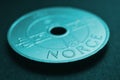 Translation: Norway. 1 Norwegian krone coin close up. National currency of Norway. Teal tinted money background for news about Royalty Free Stock Photo