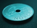 Translation: Norway. 1 Norwegian krone coin close-up. National currency of Norway. Turquoise tinted money background for news Royalty Free Stock Photo