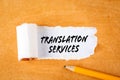 Translation Services. Business concepts. Pencil on an orange cardboard background