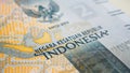 Translation: Unitary state of Republic of Indonesia. Fragment of 2000 rupiah banknote. Illustration about economy or banks. Money