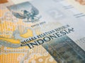 Translation: Unitary state of Republic of Indonesia. Fragment of 2000 rupiah banknote. Illustration about economy or banks. Money