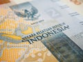 Translation: Unitary state of Republic of Indonesia. Fragment of 2000 rupiah bill. Illustration about economy or finance. Money