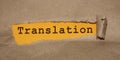 Translation word written under torn paper. Multicultural business concept