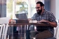 Translator wearing glasses working remotely from cafeteria Royalty Free Stock Photo