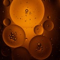 Translucent bubbles of varying sizes float against an amber background, creating an Royalty Free Stock Photo
