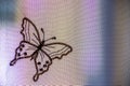 translucent curtain with butterfly embroidered in black thread.