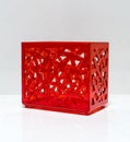 Translucent red plastic box with perforated pattern body Royalty Free Stock Photo