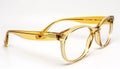 Translucent yellow eyeglass frames isolated on white background. Generative AI Royalty Free Stock Photo