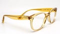 Translucent yellow eyeglass frames isolated on white background. Generative AI