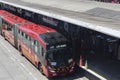 A transmilenio bus piciking up passenger at Portal del norte central station on sunny day