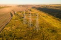 Transmission High voltage line tower in countryside landscape at sunset Royalty Free Stock Photo