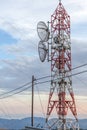 Transmission lines passing through broadcast tower. Satellite disk mounted in the microwave antenna. Wooden electrical post connec Royalty Free Stock Photo