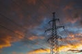 Transmission power tower on background of dramatic colorful sky. Lattice tower, used to support an overhead power line Royalty Free Stock Photo