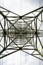 Transmission tower bottom view. Power tower on cloudy sky. Electricity pylon structure for power line. High voltage post