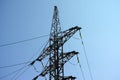 A transmission tower with electrical wires on it against blue sky Royalty Free Stock Photo