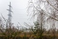 A transmission tower or electricity pylon. Steel lattice tower, used to support an overhead power line. The sky is covered with Royalty Free Stock Photo