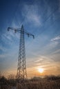 Transmission tower - high voltage power lines in colorful sunset Royalty Free Stock Photo