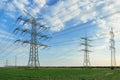 Transmission tower overhead line masts, a lot of high-voltage power line, high voltage pylons also known as power pylons on the fi Royalty Free Stock Photo