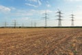 Transmission tower overhead line masts, a lot of high-voltage power line, high voltage pylons also known as power pylons on the fi Royalty Free Stock Photo