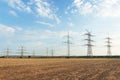 Transmission tower overhead line masts, a lot of high-voltage power line, high voltage pylons also known as power pylons on the fi Royalty Free Stock Photo