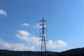 A transmission tower supports overhead power lines Royalty Free Stock Photo
