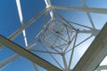 Transmission tower, view from below. Overhead pylon power line tower, distribution and transmit electrical energy across large