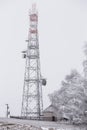 Transmission tower in winter, Telecommunications tower with cell Royalty Free Stock Photo